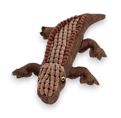 Brown fabric crocodile toy with textured scales and yellow eyes