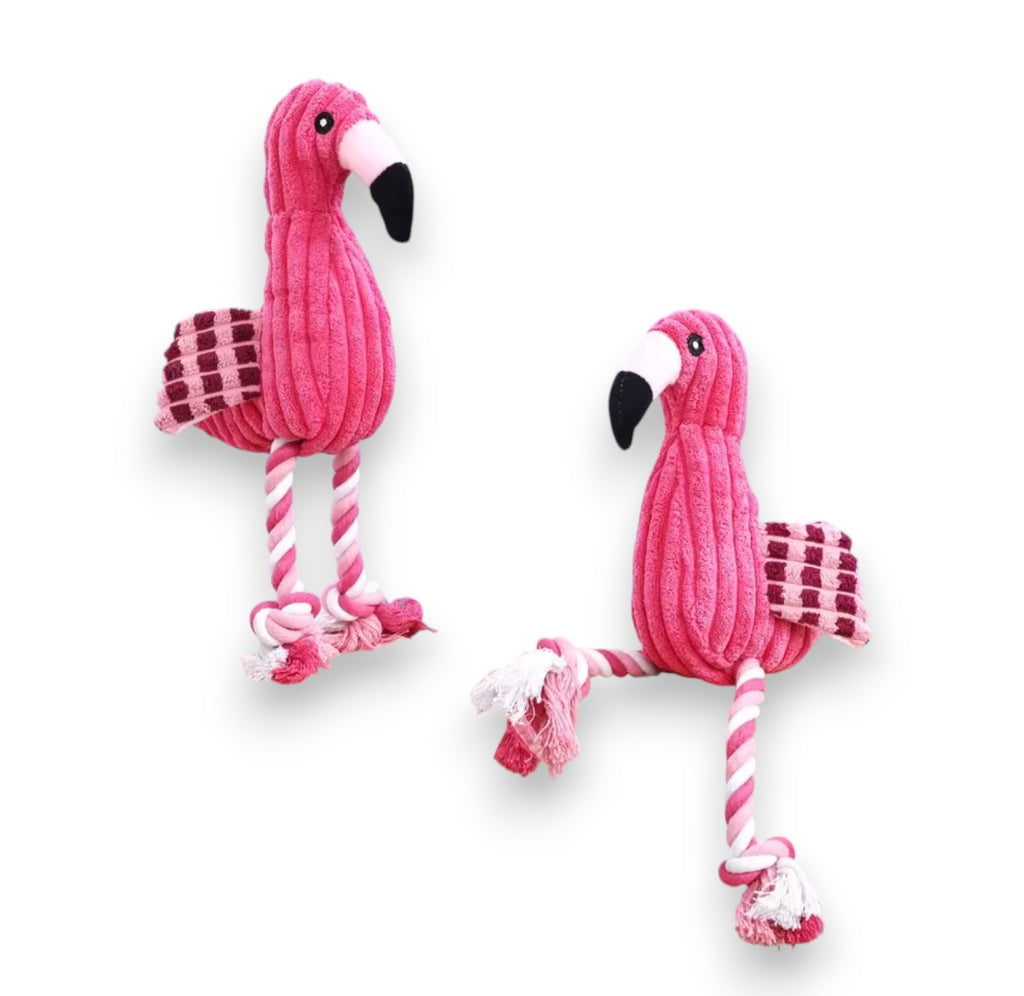 Two pink corduroy flamingo dog toys with rope legs and checkered wings.