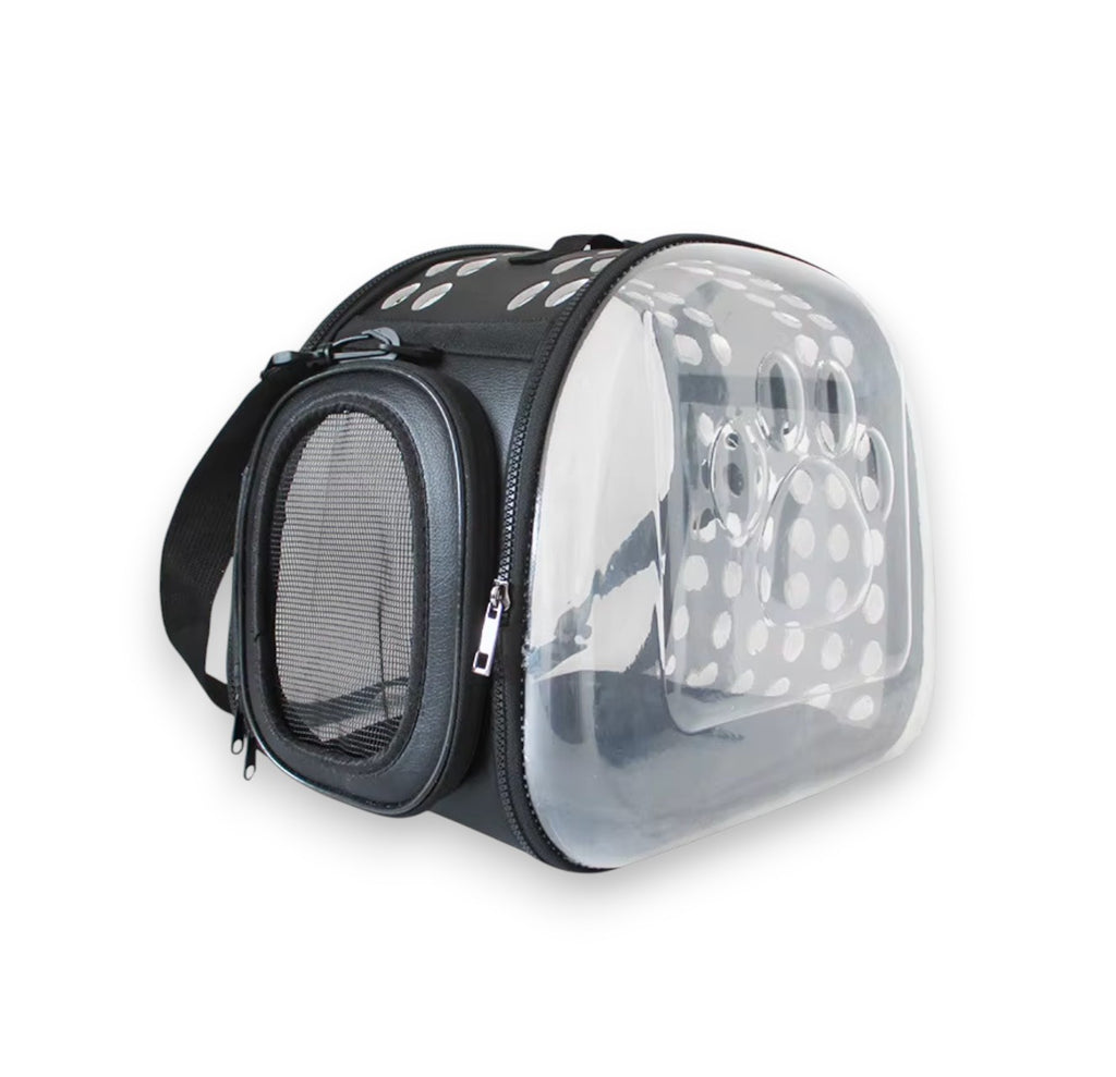 Black pet carrier bag with clear dome window featuring a paw print and white polka dots, plus a mesh side window.