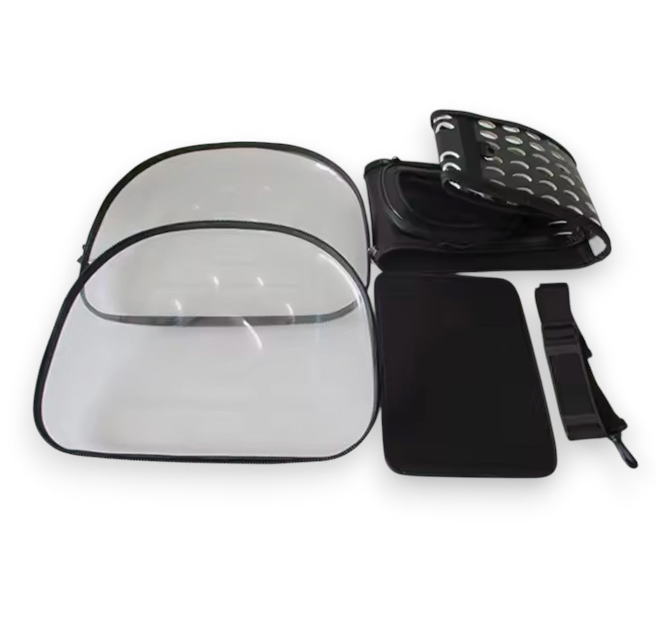Disassembled black and clear portable pet carrier with transparent plastic panels, a ventilated fabric top, and a strap.